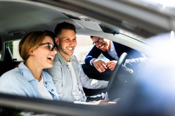 two people laughing in car